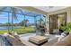 Screened patio with comfortable seating, grill, and serene lake view at 6915 Honeysuckle Trl, Lakewood Ranch, FL 34202