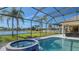 Screened pool and spa area with a view of the lake and palm trees at 6915 Honeysuckle Trl, Lakewood Ranch, FL 34202