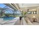 Relaxing pool area with screened enclosure overlooking the lake and landscaping at 6915 Honeysuckle Trl, Lakewood Ranch, FL 34202