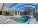 Screened pool and spa with a paver deck and clear blue sky at 6915 Honeysuckle Trl, Lakewood Ranch, FL 34202