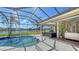 Relaxing pool area with screened enclosure overlooking the lake and landscaping at 6915 Honeysuckle Trl, Lakewood Ranch, FL 34202