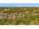 Scenic aerial view of the community showcasing tree-lined streets and well-maintained rooftops at 7713 Fairway Woods Dr # 902, Sarasota, FL 34238