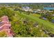 Beautiful aerial view of real estate on a golf course with mature trees and lovely homes at 7713 Fairway Woods Dr # 902, Sarasota, FL 34238