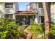 A lush backyard featuring tropical landscaping and a screened in lanai for enjoying the outdoors at 7713 Fairway Woods Dr # 902, Sarasota, FL 34238