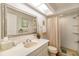 Clean bathroom with a white vanity, large mirror, and a shower with a neutral-toned curtain at 7713 Fairway Woods Dr # 902, Sarasota, FL 34238