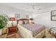 Comfortable bedroom featuring a queen bed with patterned bedding and two side tables with lamps at 7713 Fairway Woods Dr # 902, Sarasota, FL 34238