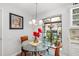 Cozy breakfast nook featuring a glass table with seating for four, a window and stylish lighting at 7713 Fairway Woods Dr # 902, Sarasota, FL 34238
