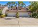 Well-maintained townhomes with attached garages, showcasing lovely curb appeal and landscaping at 7713 Fairway Woods Dr # 902, Sarasota, FL 34238