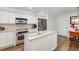 Compact kitchen with stainless steel appliances and white cabinetry at 7713 Fairway Woods Dr # 902, Sarasota, FL 34238