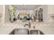 Close up of the kitchen sink with a view into the bright and open living room space at 7713 Fairway Woods Dr # 902, Sarasota, FL 34238