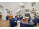 Bright living room with high ceilings, a fireplace, and comfortable blue furnishings at 7713 Fairway Woods Dr # 902, Sarasota, FL 34238