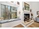 Cozy living room with a large window, fireplace and a comfortable window bench at 7713 Fairway Woods Dr # 902, Sarasota, FL 34238