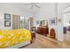 Bedroom featuring hardwood floors, natural light from sliding glass doors, and stylish furniture at 7713 Fairway Woods Dr # 902, Sarasota, FL 34238