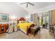 Bedroom with hardwood floors and a view of the screened patio, creating a peaceful retreat at 7713 Fairway Woods Dr # 902, Sarasota, FL 34238
