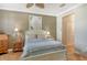 Comfortable bedroom with a ceiling fan, neutral decor, and convenient access to closet and hallway at 7979 Limestone Ln # 14-101, Sarasota, FL 34233