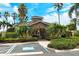 Community clubhouse features well-manicured landscaping, accessible parking, and gated entry at 7979 Limestone Ln # 14-101, Sarasota, FL 34233