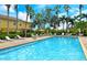 Community pool with plenty of lounge chairs and lush landscaping, perfect for relaxation at 7979 Limestone Ln # 14-101, Sarasota, FL 34233