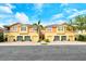 Sunny townhome exteriors with garages at 7979 Limestone Ln # 14-101, Sarasota, FL 34233