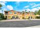 Well-maintained townhouses featuring colorful exteriors, garages, and manicured landscaping at 7979 Limestone Ln # 14-101, Sarasota, FL 34233