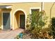 Charming front entrance with well-maintained landscaping and welcoming arched entryway at 7979 Limestone Ln # 14-101, Sarasota, FL 34233