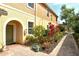 Attractive home exterior showcasing a brick walkway and colorful front garden at 7979 Limestone Ln # 14-101, Sarasota, FL 34233