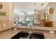 View from the kitchen bar into the living room at 7979 Limestone Ln # 14-101, Sarasota, FL 34233