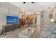 Inviting living room showcasing neutral tones, a large TV, and seamless flow into the dining and kitchen areas at 7979 Limestone Ln # 14-101, Sarasota, FL 34233