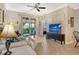 Inviting living area featuring neutral tones, comfortable seating, and access to the screened patio at 7979 Limestone Ln # 14-101, Sarasota, FL 34233