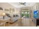 Bright living room with neutral decor, tile floors, comfortable seating, and access to outdoor views at 7979 Limestone Ln # 14-101, Sarasota, FL 34233