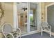 Cozy patio with seating offering serene views of the living room and the outdoors at 7979 Limestone Ln # 14-101, Sarasota, FL 34233