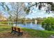 Relaxing pond view with bench seating, shimmering water, and lush landscaping at 7979 Limestone Ln # 14-101, Sarasota, FL 34233