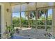 Relaxing screened patio with views of the landscaped backyard with decorative plants at 7979 Limestone Ln # 14-101, Sarasota, FL 34233