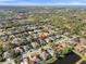 Aerial view of neighborhood featuring lush landscaping, community lake, and proximity to the ocean at 826 Oak Briar Ln, Osprey, FL 34229