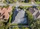 Aerial view of a well-maintained single-Gathering home with a screened-in pool and lush landscaping at 826 Oak Briar Ln, Osprey, FL 34229