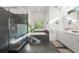 Bright bathroom with a glass shower, soaking tub, and double vanity with modern fixtures at 826 Oak Briar Ln, Osprey, FL 34229