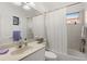 Cozy bathroom with a shower-tub combo, neutral tile, and a vanity with a sink at 826 Oak Briar Ln, Osprey, FL 34229