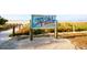 Siesta Beach sign that says #1 Beach in the USA surrounded by sand and grass and a pathway to the beach at 826 Oak Briar Ln, Osprey, FL 34229