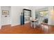 Open dining room boasts a sleek hardwood floor, modern furniture, and ample natural light from sliding glass doors at 826 Oak Briar Ln, Osprey, FL 34229