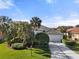 Charming single-story home featuring mature landscaping and a well-maintained driveway leading to a two-car garage at 826 Oak Briar Ln, Osprey, FL 34229