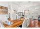 Bright foyer and dining area feature hardwood floors, modern decor, and plantation shutters at 826 Oak Briar Ln, Osprey, FL 34229