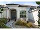 Attractive home entrance with a modern front door, decorative stone landscaping, and charming outdoor seating at 826 Oak Briar Ln, Osprey, FL 34229
