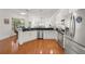 Open kitchen featuring white cabinets, stainless steel appliances, and an island with breakfast bar at 826 Oak Briar Ln, Osprey, FL 34229