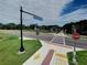 View of the Legacy Trail entrance sign, a pedestrian crosswalk, and nearby greenery at 826 Oak Briar Ln, Osprey, FL 34229