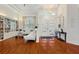 Bright living room with high ceilings, hardwood floors, and a built-in bookcase for ample storage at 826 Oak Briar Ln, Osprey, FL 34229