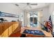 Well-lit office features hardwood floors and a large window with view to pool area at 826 Oak Briar Ln, Osprey, FL 34229