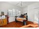 Well-lit office features hardwood floors and a large window with shutters at 826 Oak Briar Ln, Osprey, FL 34229