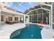 Beautiful screened-in pool with spacious patio, complemented by lush greenery and outdoor seating area at 826 Oak Briar Ln, Osprey, FL 34229