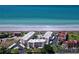 Stunning aerial view of the Island Reef community with beachfront access and lush greenery, showcasing the desirable location at 8779 Midnight Pass Rd # 106H, Sarasota, FL 34242