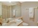 Bathroom featuring a single sink vanity, framed mirror, and a curtained shower/tub at 8779 Midnight Pass Rd # 106H, Sarasota, FL 34242