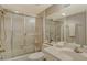 Bathroom with shower behind sliding glass doors and a toilet next to the sink at 8779 Midnight Pass Rd # 106H, Sarasota, FL 34242